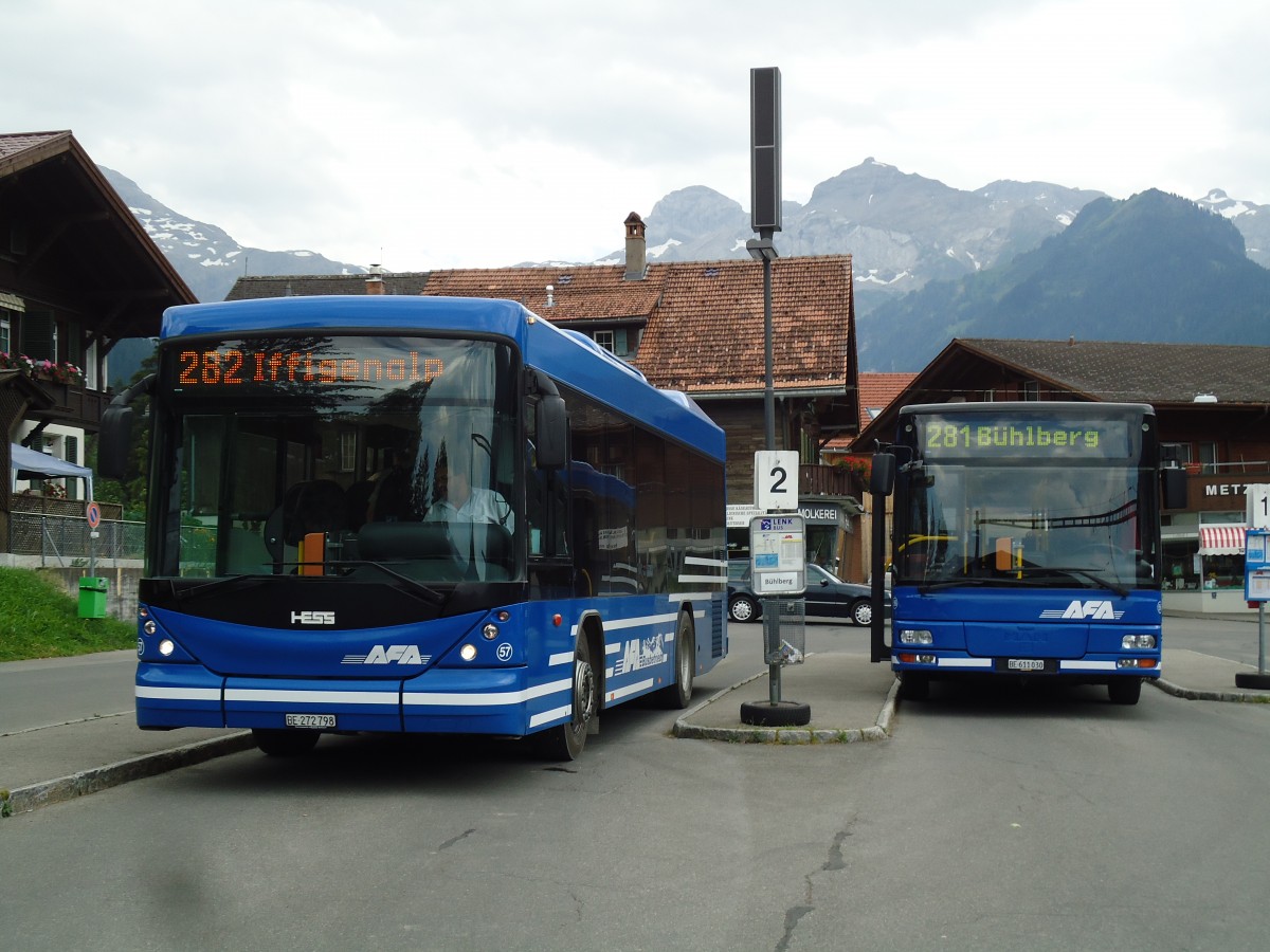 (146'150) - AFA Adelboden - Nr. 57/BE 272'798 - Scania/Hess + Nr. 56/BE 611'030 - MAN/G�ppel am 28. Juli 2013 beim Bahnhof Lenk